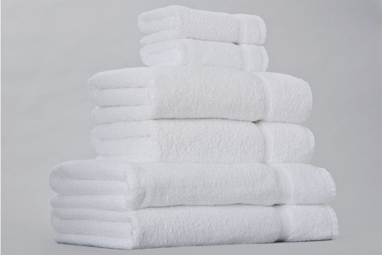 A stack of white EuroTouch towels for hotels.