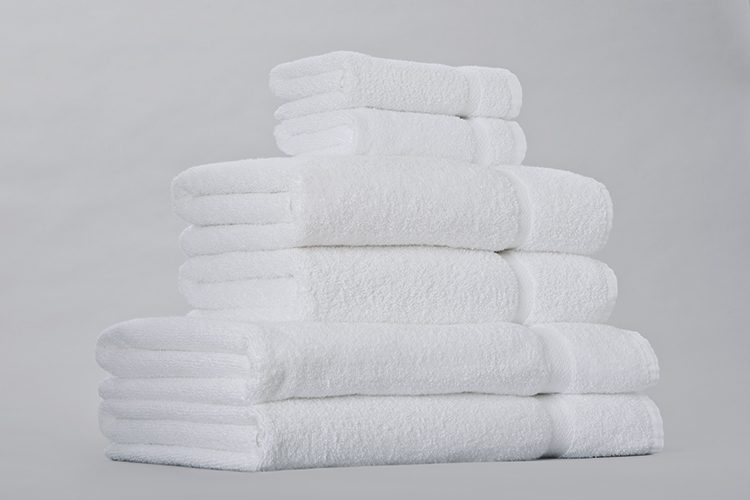 A stack of folded EuroTouch towels in several different sizes.