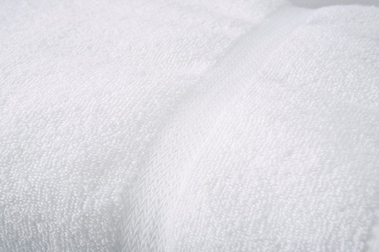 Detail of a white EuroTouch towel for hotels.