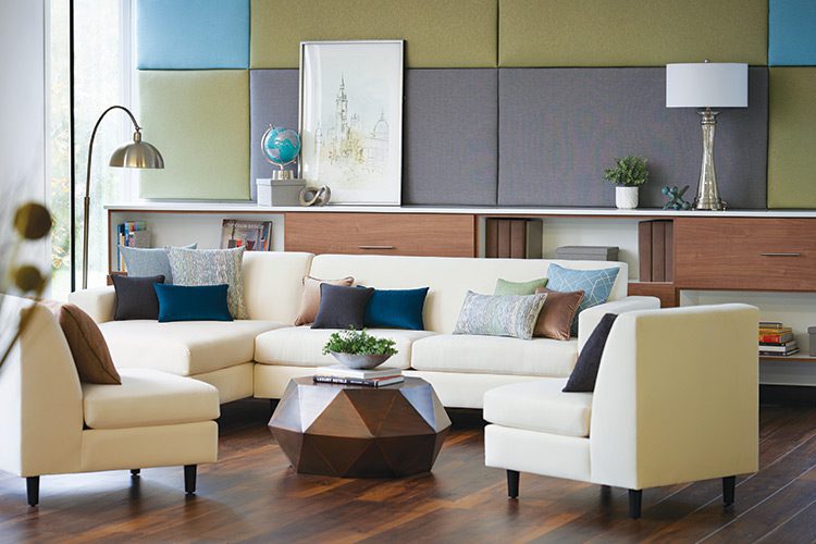 Interior Fabric Collection shown on pillows on an ivory couch and chairs.