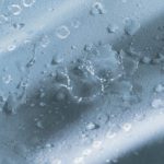 Impact technology makes the fabric water-resistant. The image shows water beading on the fabric