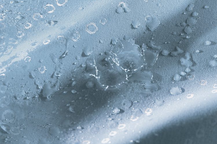 Impact technology makes the fabric water-resistant. The image shows water beading on the fabric