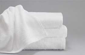 This is a stack of three towels for hotels. The ForeverSoft bath towels have one towel artistically draped over over the others.