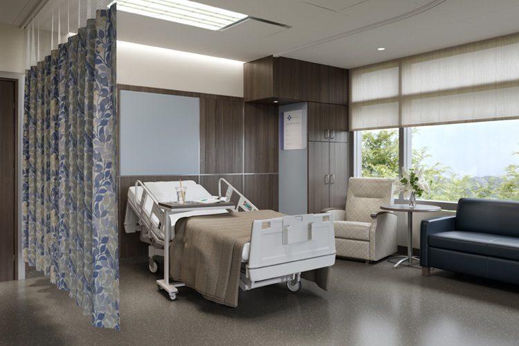 A healthcare patient room featuring privacy curtains, a patient bed, a chair, and a sofa.