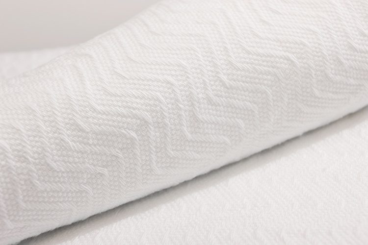 Detail of a herringbone blanket in bleached.
