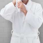 A man wearing a HoneyComb hotel robe.