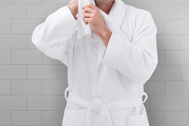 A man wearing a HoneyComb hotel robe.