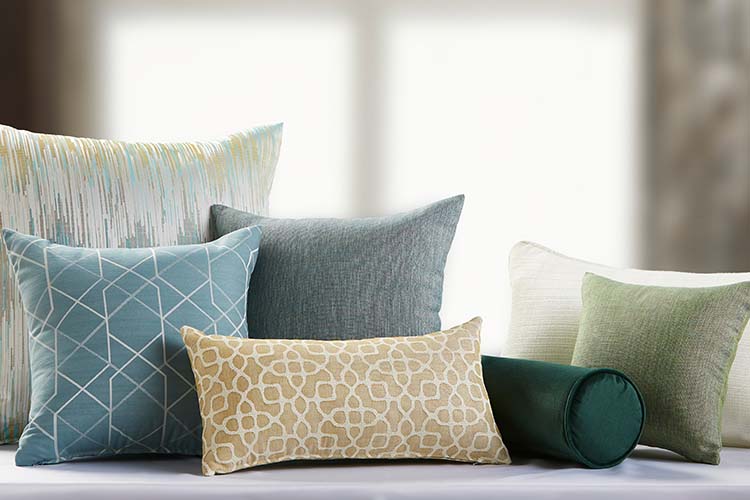 A group of decorative throw pillows featuring a variety of colors and patterns.