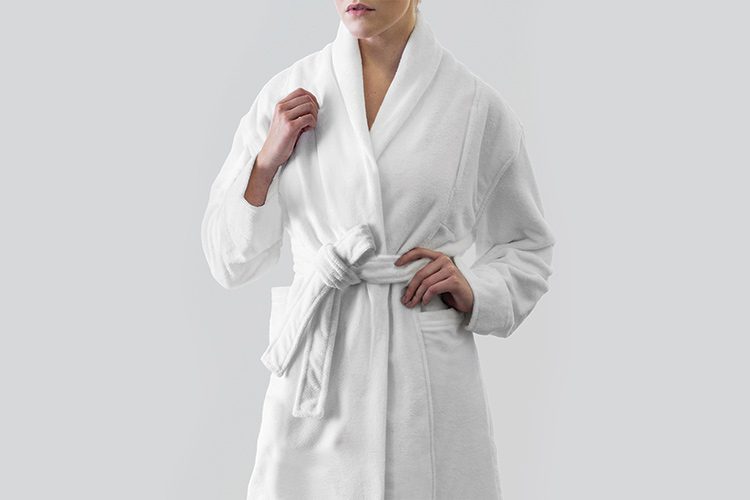 A woman wearing a Heidi Weisel Logan hotel bathrobe.