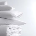 A stack of pillows and LuxSoft Comforter.