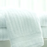 A stack of three folded Luxury Stripe bath towels.