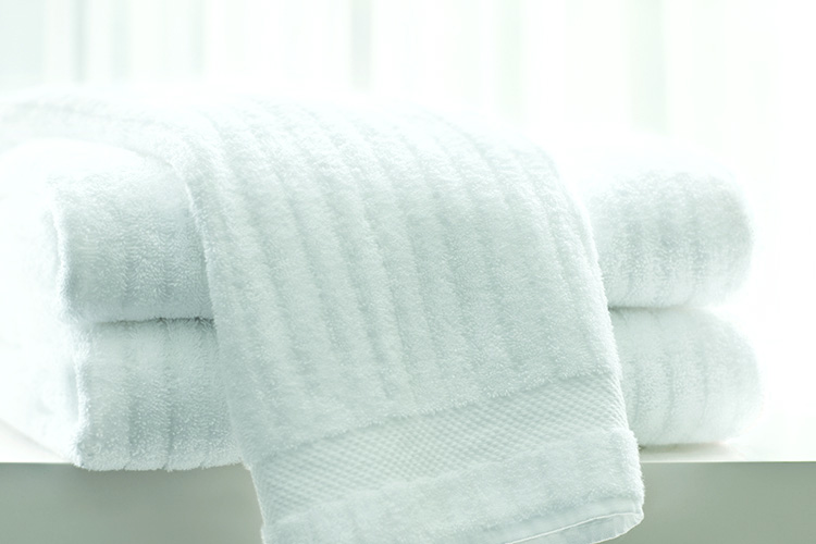 A stack of three folded Luxury Stripe bath towels.