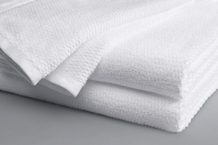 A folded Lynova blanket with edge detail in white.