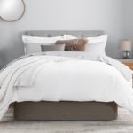 A beautifully made bed featuring a modern Circa Bed Wrap in the color SmokeyQuartz.