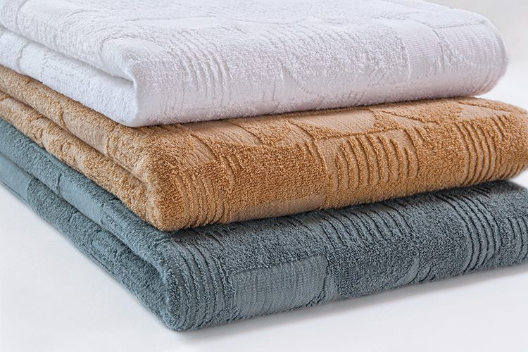 A stack of three folded Moonphase blankets.
