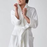 A woman wearing a Heidi Weisel Nikki hotel bathrobe.