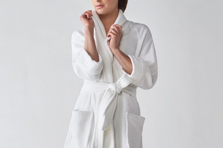A woman wearing a Heidi Weisel Nikki hotel bathrobe.