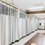 A hallway of hospital privacy cubical curtains in a healthcare facility.