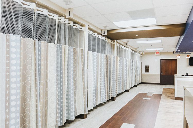 A hallway of hospital privacy cubical curtains in a healthcare facility.