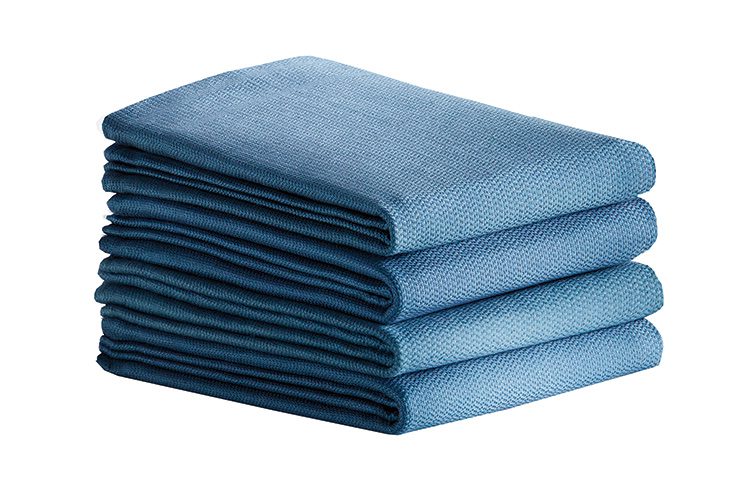 A stack of four folded PerVal Surgical Towels.