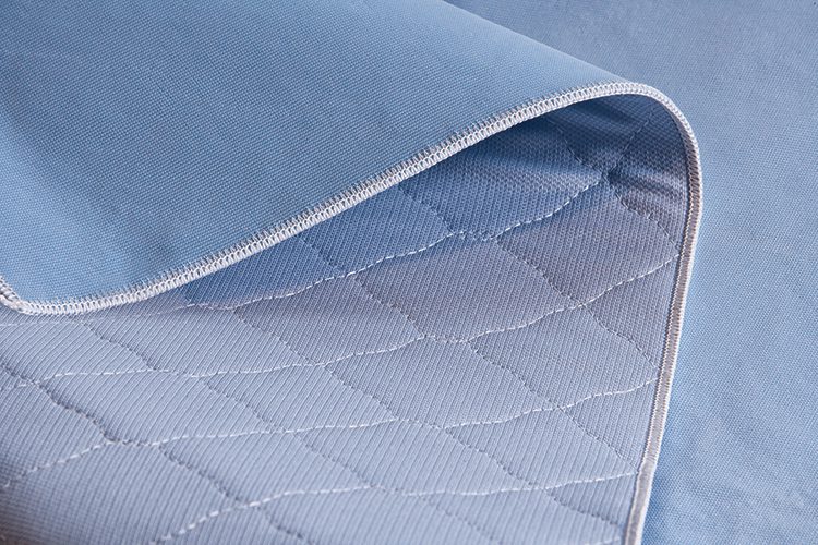 A detail shot of PerVal reusable underpads. These hospital bed pads are of patented tri-component construction. Reusable incontinence pads like PerVal® disperse moisture more effectively than brushed-tricot underpads.