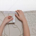 Hands showing how to replace privacy curtain.