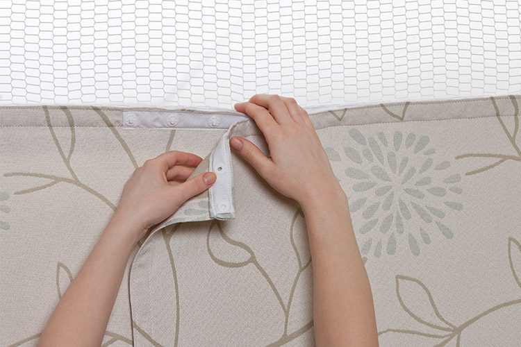 Hands showing how to replace privacy curtain.