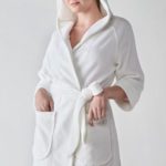 A woman wearing a Heidi Weisel Rachel hotel robe.