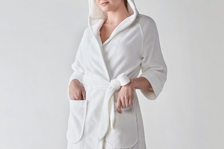 A woman wearing a Heidi Weisel Rachel hotel robe.