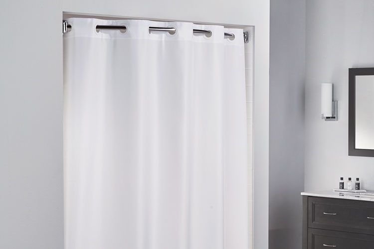 Image of a white grommeted hotel shower curtain.