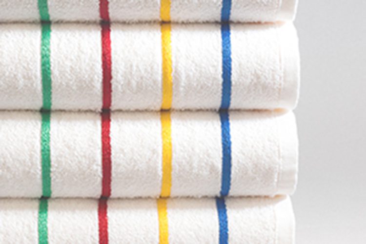 Image of white pool towel with colorful primary stripes.