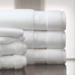 A stack of white TAL Braque Terry Towels, handtowels and washtowels.