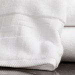 A stack of towels showing the unique TAL Braque terry cam border.