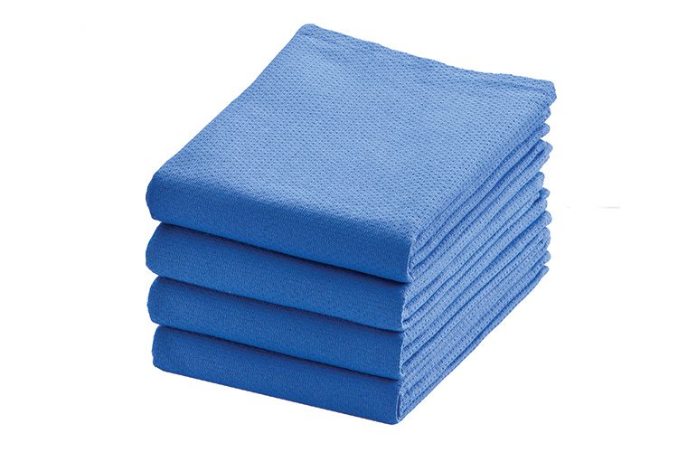 A stack of four folded ToughWeave surgical towels.