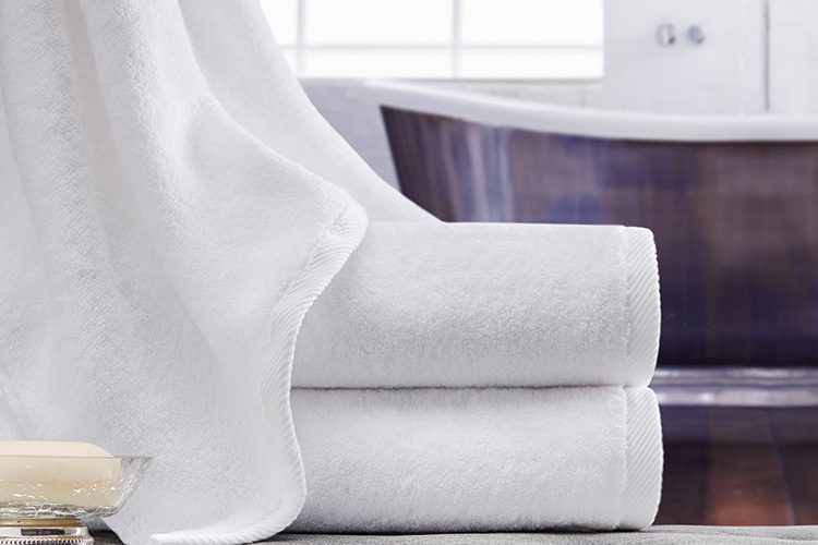 Stack of two vidori luxury hotel towels with a third draped over the top