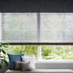 Window with a shade and a fabric cornice top treatment.