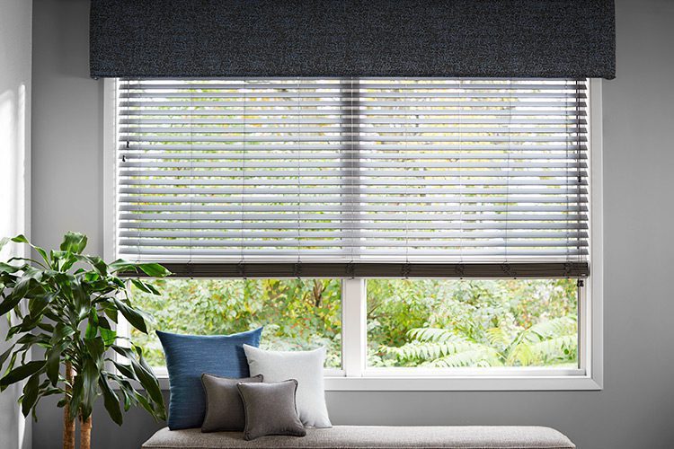 Window with a shade and a fabric cornice top treatment.