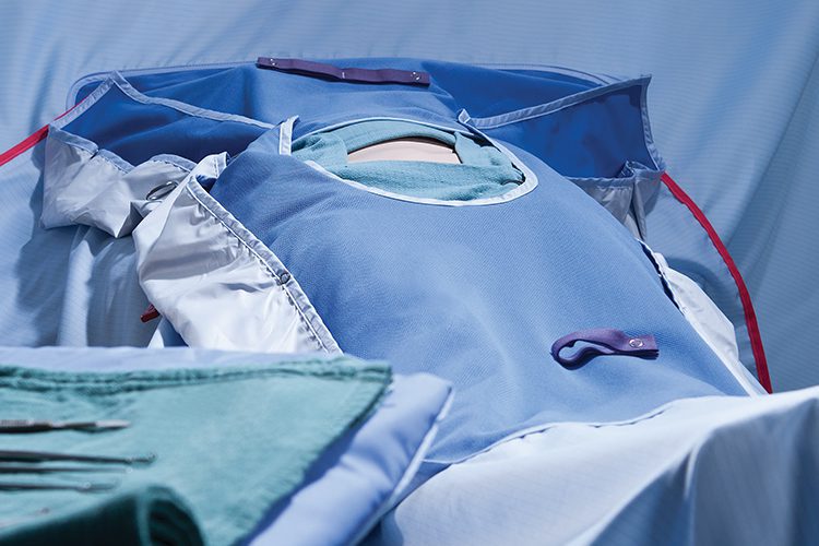 A staged surgery scene featuring all the linens, wraps, towels, etc required for a procedure. The Compel surgical wrapper is seen prominently.