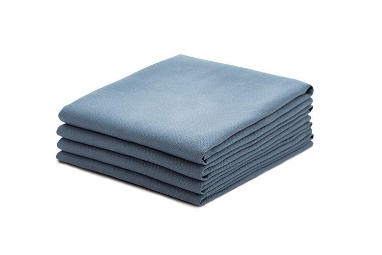 A stack of four folded E Star surgical towels.