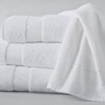 A stack of three folded Healing Spaces bath towels.