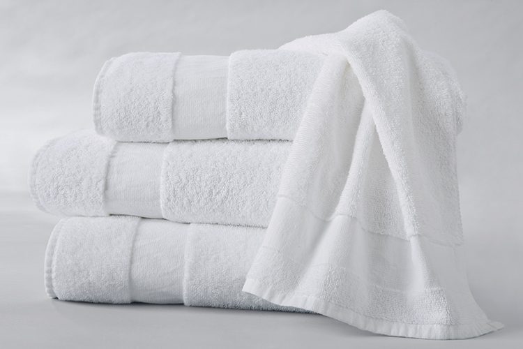 A stack of three folded Healing Spaces bath towels.