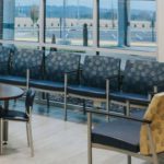 A hospital waiting room with chairs in a beautiful circular blue Pattern is seen here.