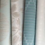 Several pieces of fabric in a variety of colors and patterns, stacked next to each other.
