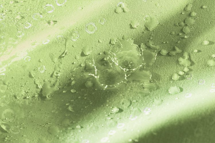 A detail shot showing water beading and rolling off of Impact fabric.