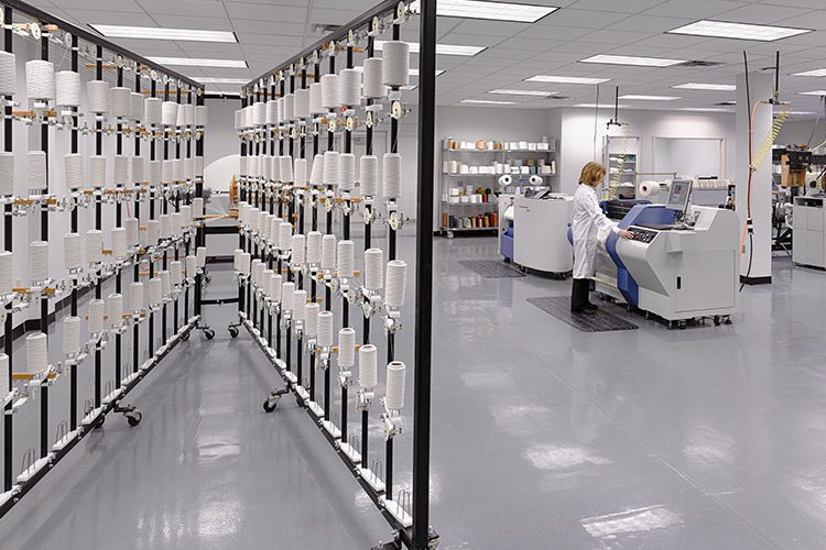 A behind the scenes look into our CORE facility prototyping room, various yarn and weaving machines are visible.