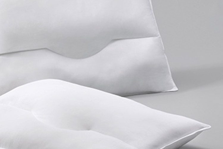 Two SoftSupport pillows on a grey background.