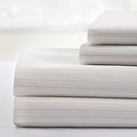 This image shows a stack of our DermaTherapy® Sheets. Their silk-like texture has been proven to reduce the likelihood of patients developing pressure injuries.