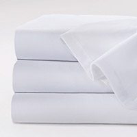 This stack of white sheets is our Excel® sheets and pillowcases. The high cotton content will make patients will feel like they are sleeping at home.