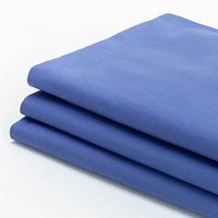 Image of a stack of blue sheets. These sheets are 100% cotton.