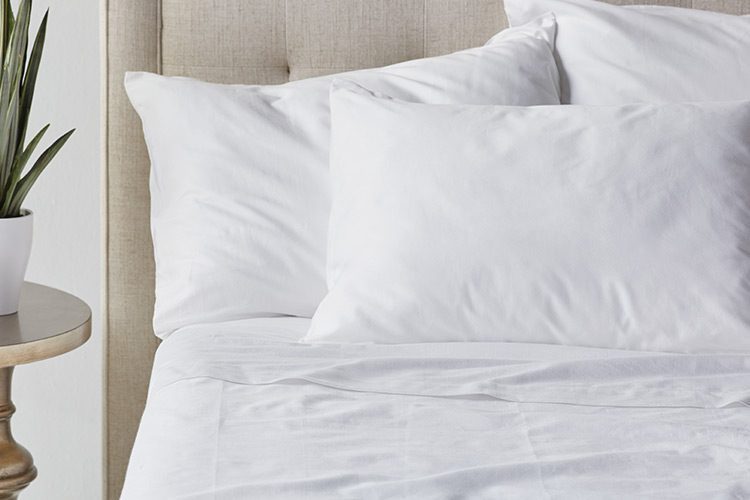 A cropped shot of a hotel bed featuring Paragon Cotton sheets.